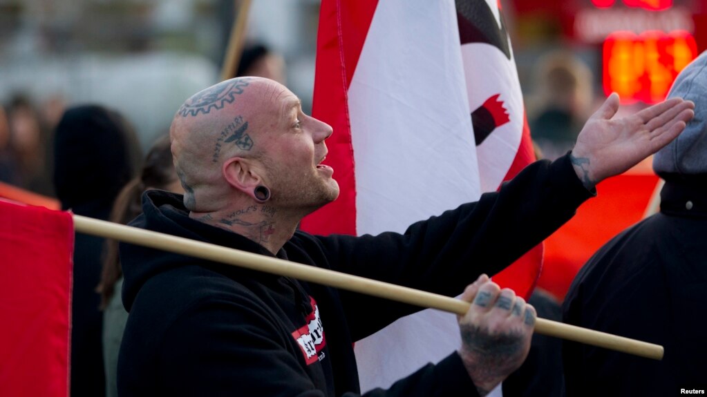 A supporter of the far-right nationalist National Democratic Party of Germany (NPD) attends a rally in Berlin April 13, 2012. Some 50 extreme-right supporters of the NPD marched on Friday through a Berlin suburb, demanding Germany dropped the Euro currenc