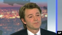 France's Finance and Economy Minister Francois Baroin is seen in this still image taken from video as he speaks on national TV after the downgrade of France's AAA rating, in Paris, January 13, 2012.