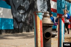 A mural and painted pipes in the colors of Puerto Rico's and Cuba's flags brighten the streets of East Harlem, New York, home to one of the largest Puerto Rican diaspora communities in the U.S. (R. Taylor/VOA)