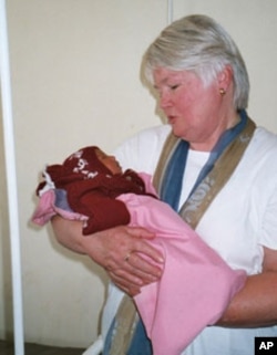 Jill Sheffield holds a baby born to a mother at one of the FCI-affiliated maternal health clinics in Ecuador.