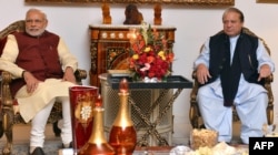 FILE - Indian Prime Minister Narendra Modi, left, and Pakistan Prime Minister Nawaz Sharif meet in Lahore after Modi paid a surprise visit, Dec. 25, 2015.