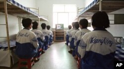 Falun Gong practitioners watch a video about a solar eclipse, part of deprogramming efforts enforced at the Masanjia Reeducation-through-labor camp in northeast China's Liaoning province. (file photo)