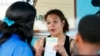 FILE - Jessica Jones, center, speaks to people about Amendment 4 at Charles Hadley Park in Miami, Oct. 22, 2018. Amendment 4 asked voters to restore the voting rights of people with past felony convictions, and Floridians approved it on Nov. 6, 2018. 