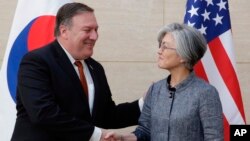 FILE - U.S. Secretary of State Mike Pompeo, left, shakes hands with South Korean Foreign Minister Kang Kyung-wha at South Korea's mission, July 20, 2018, in New York.
