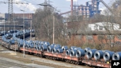 FILE - Steel coils sit on wagons when leaving the thyssenkrupp steel factory in Duisburg, Germany, March 2, 2018.
