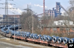 FILE - Steel coils sit on wagons when leaving the thyssenkrupp steel factory in Duisburg, Germany, March 2, 2018.