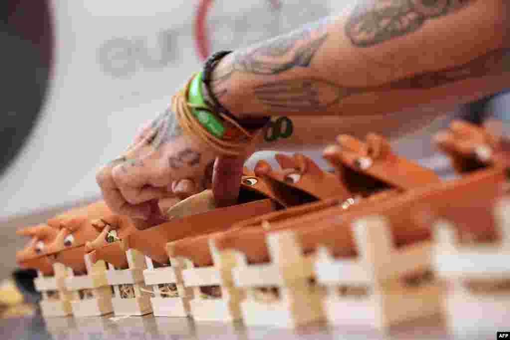 A chef prepares a snack during the final phase of the 10th edition of the National Skewers and Tapas competition held in Valladolid, Spain. 