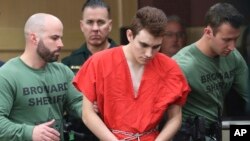 Nikolas Cruz is lead into the courtroom before being arraigned at the Broward County Courthouse in Fort Lauderdale, Fla., on Wednesday, March 14, 2018. (Amy Beth Bennett/South Florida Sun-Sentinel via AP, Pool)