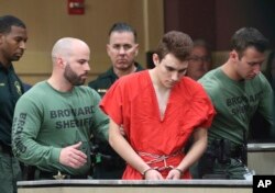 Nikolas Cruz is lead into the courtroom before being arraigned at the Broward County Courthouse in Fort Lauderdale, Fla., on Wednesday, March 14, 2018. (Amy Beth Bennett/South Florida Sun-Sentinel via AP, Pool)