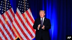 President Donald Trump applauds after delivering a speech, laying out a national security strategy, in Washington, Dec. 18, 2017.