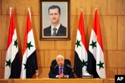 In this photo released by the Syrian official news agency SANA, Syrian Foreign Minister Walid al-Moallem speaks during a press conference in Damascus, Syria, May 8, 2017.