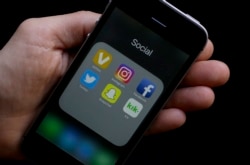 FILE - Some social media apps on a smartphone.