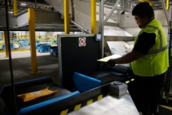 facility in Goodyear, Ariz. Warehouses powered by robotics and AI software are leading to human burnout by adding more work and upping the pressure on workers to speed up their performance, said Beth Gutelius, who studies urban economic development at the University of Illinois at Chicago and has interviewed warehouse operators around the U.S. (AP Photo/Ross D. Franklin)