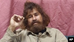 Jose Salvador Alvarenga sits on a couch in Majuro in the Marshall Islands, after he was rescued from being washed ashore on the tiny atoll of Ebon in the Pacific Ocean, Feb. 3, 2014.