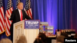 Republican U.S. presidential candidate Donald Trump speaks in front of a display of Trump water, wine and steaks as he talks about the results of the Michigan, Mississippi and other primary elections during a news conference held at his Trump National Club in Jupiter, Florida, March 8, 2016.
