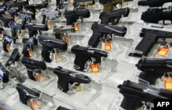 FILE - Guns are for sale at the South Florida Gun Show at the Dade County Fairgrounds in Miami, Florida, Feb. 16, 2018.