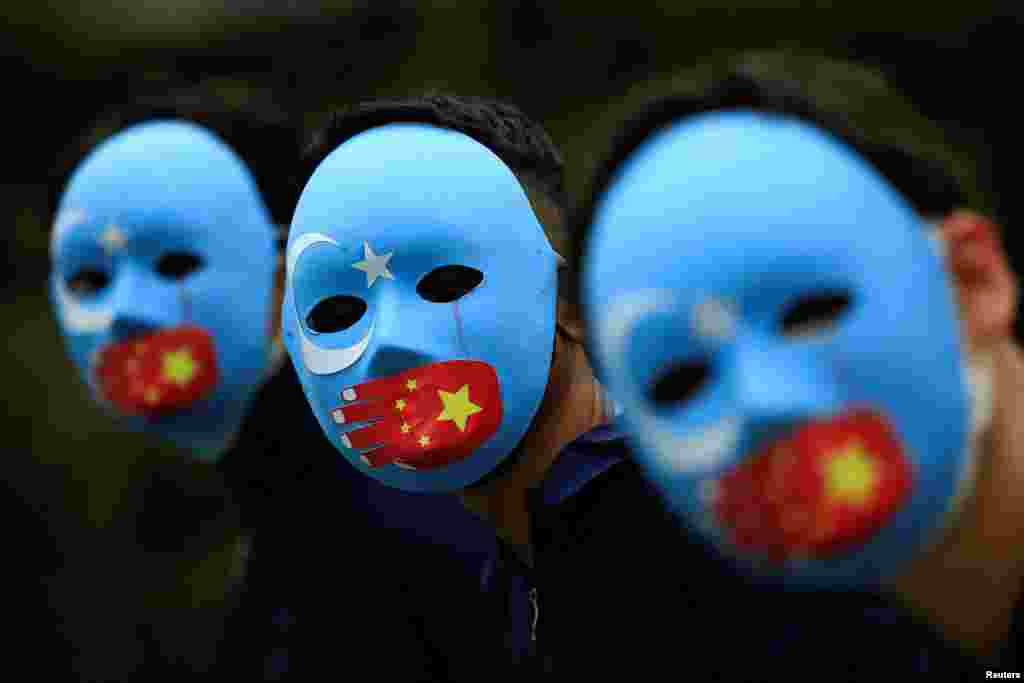 Activists take part in a protest against China&#39;s treatment toward the ethnic Uyghur people and calling for a boycott of the 2022 Winter Olympics in Beijing, at a park Jakarta, Indonesia.