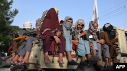 Taliban fighters in a vehicle patrol the streets of Kabul, Afghansitan.