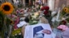 FILE - In this Thursday, July 8, 2021, photo, tributes mark the spot where journalist Peter R. de Vries was shot in Amsterdam, Netherlands. 