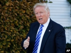 FILE - President-elect Donald Trump gives the thumbs-up as he arrive at the Trump National Golf Club Bedminster clubhouse in Bedminster, N.J.