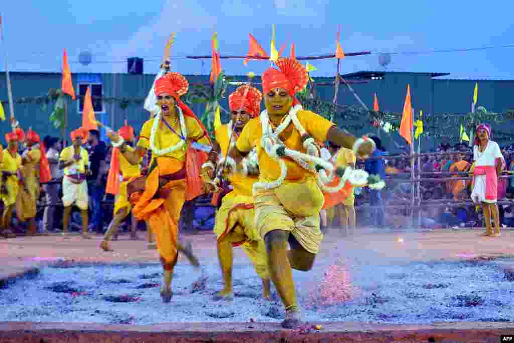 Hindu devotees run through red hot embers as part of annual fire walking ritual during &#39;Draupadi Amman&#39; festival in Bangalore, India.