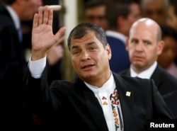 FILE - Ecuador's President Rafael Correa waves prior to a governmental ceremony in Buenos Aires, Argentina, Dec. 10, 2015. Correa recently expressed admiration for Hillary Clinton and said he hoped she wins the U.S. presidential election.