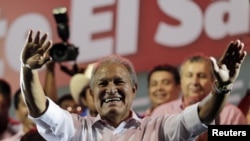 Salvador Sanchez Ceren, the presidential candidate for the Farabundo Marti National Liberation Front (FMLN), waves to his supporters before giving a speech, after the official election results were released, in San Salvador, March 9, 2014.