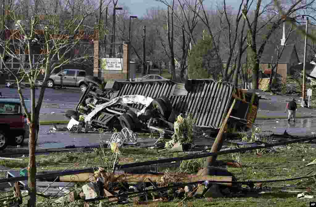 A school bus was flipped and ripped apart in the parking lot of Henryville High School in Henryville, Indiana, after a tornado touchdown. (AP)