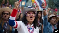 Anti-government People's Democratic Reform Committee protesters cheer at an encampment in the Pathumwan district in Bangkok, Jan. 16, 2014.