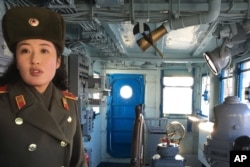 A North Korean military guide leads a tour of the USS Pueblo in Pyongyang, North Korea, Jan. 24, 2018. The Pueblo, an American spy ship, was attacked and captured by North Korea 50 years ago this week.
