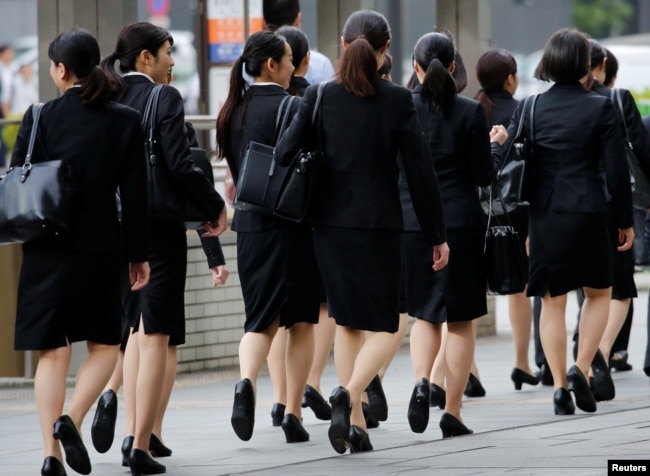 FILE - Female office workers wearing business clothes in Tokyo, Japan, June 4, 2019. (REUTERS/Kim Kyung-Hoon)