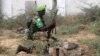 FILE - An African Union Mission in Somalia (AMISOM) peacekeeper from Burundi holds a position before being replaced by the Somali military at Jaale Siad Military academy in Mogadishu, Somalia. Feb. 28, 2019.