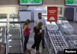 People shop inside Khoury Home, an appliance store in Dora, east of Beirut, Lebanon, Aug. 6, 2018.