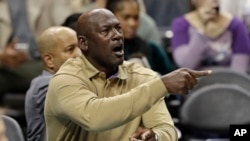 Charlotte Hornets owner Michael Jordan shouts to his team during the first half of an NBA basketball game against the Utah Jazz in Charlotte, N.C., Jan. 12, 2018.