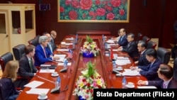U.S. Secretary of State John Kerry addresses Chinese Foreign Minister Wang Yi and his delegation at the National Convention Center in Vientiane, Laos, on July 25, 2016, during the outset of a bilateral meeting on the sidelines the annual meeting of the ASEAN meeting. 