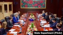 U.S. Secretary of State John Kerry (left) addresses Chinese Foreign Minister Wang Yi and his delegation at the National Convention Center in Vientiane, Laos, on July 25, 2016.