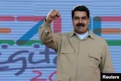 FILE - Venezuela's President Nicolas Maduro gestures during a meeting with supporters in Caracas, March 31, 2017. (Miraflores Palace/Handout)