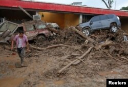 A man walks among the ruins after flooding and mudslides, caused by heavy rains leading several rivers to overflow, pushing sediment and rocks into buildings and roads, in Mocoa, Colombia, April 2, 2017.