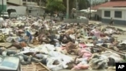 Bodies from the Haitian earthquake can be seen on the side of the road in Port-au-Prince
