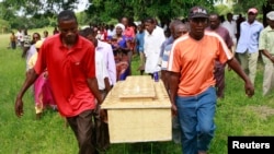 FILE - Pallbearers carry a coffin containing the remains of Francis Kamande killed when gunmen attacked the coastal Kenyan town of Mpeketoni, June 18, 2014. 