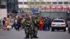 Paramilitary policemen stand guard near the exit of the South Railway Station, where three people were killed and 79 wounded in a bomb and knife attack on Wednesday, in Urumqi, Xinjiang Uighur Autonomous region, May 1, 2014.