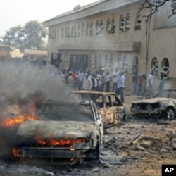 A car burns at the scene of a bomb explosion at St. Theresa Catholic Church at Madalla, Suleja, just outside Nigeria's capital Abuja, December 25, 2011.