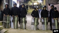 Security forces guard a street leading to the church were an explosion left one policeman dead and two more injured, in Cairo, Jan. 5, 2019.