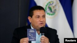 El ministro de Trabajo de El Salvador, Rolando Castro, muestra su pasaporte durante una conferencia de prensa mientras dijo que renuncia a solicitar una visa estadounidense después de ser mencionado en la lista de Engel en San Salvador, El Salvador.