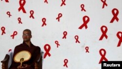 FILE - A Buddhist monk waits to pray at a World AIDS Day commemoration in Colombo, Sri Lanka.