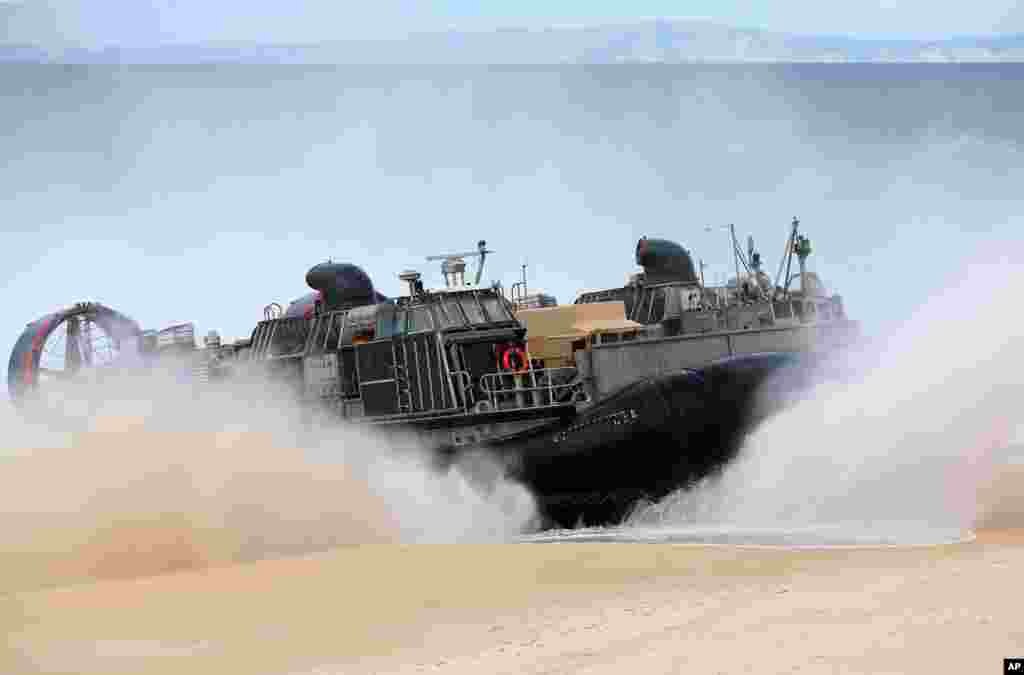A U.S. Navy hovercraft approaches the beach at the beginning of the NATO Trident Juncture exercise 2015 at Raposa Media beach in Pinheiro da Cruz, south of Lisbon. NATO Allies and partner nations join forces for the next three weeks for the Alliance&#39;s Trident Juncture live military exercise involving 36,000 troops from more than 30 nations across Portugal, Italy and Spain.
