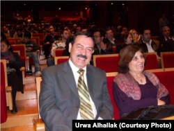 Taofik Alhallak, left, and Zahrieh Alsouso await a theater performance in Damascus in this undated photo provided by their son.
