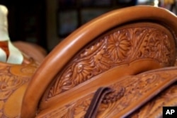 Many of Nancy Martiny's saddles are simple with the rough part of the leather exposed. Others, such as the one in this picture, sport ornate flower designs.