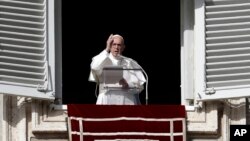 Pope Francis delivers a blessing during the Angelus noon prayer in St. Peter's Square, at the Vatican, Nov. 26, 2017. 