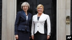 Britain's Prime Minister Theresa May, left, welcomes President Kolinda Grabar-Kitarovic of Croatia to No 10 Downing Street in London, Oct. 11, 2016.